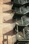 View of modern metal empty fire escape ladder near building on sunny day outdoors