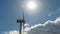 view of a modern windmill against a blue sky. The white blades of the wind turbine close up. Renewable energy source. Production