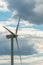 view of a modern windmill against a blue sky. The white blades of the wind turbine close up. Renewable energy source. Production