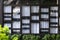 View of the modern windows and white curtain, the glass of which reflects the opposite fountain and garden. Abstract pattern