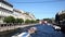 View of Moika embankment, tourist boats and Red bridge in Saint Petersburg.