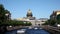 View of the Moika river embankments, the domes of St. Isaac`s Cathedral and tourist boats, St. Petersburg