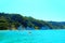 View from Molo Portonovo at the Adriatic Sea with boats, vegetation, mountains