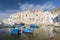 View of Monopoli harbor with colorful azure fishing boats, Apulia, Italy