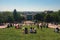 View from the Montmartre hill to the green lawn in front of the Sacre Coeur church with tourists relaxing and enjoying