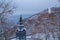 View of the monument to Vladimir the Holy through snow-covered trees in Vladimirsky park and view of the Dnieper river in the city