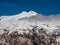 View of Mount Elbrus with snow-capped peaks against the blue sky. Karbardino-Balkaria, Russia