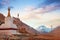 View of Mount Everest from the RongPu Monastery, at the Everest Base Camp in Tibet, against a colorful morning sky.