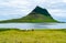 View of mount Kirkjufell with horses grazing in the field