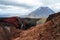 View of Mount Ngauruhoe - Mount Doom from Tongariro Alpine Crossing hike with clouds above and red crater in foreground