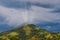 View of a mountain with a dramatic storm clouds and some sun ray