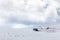 View of mountain field meadows covered by snow, with small plant