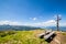 View from mountain Gasselhoehe with wooden bench to mountain Dachstein