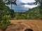 View mountain hill cloud sun shine behind cloud earth dirt way road stone bike down peak doi point chiang mai Thailand