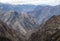 View of the mountain landscape with a pile of rocks, gorges and steep slopes