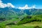 View of the mountain peaks of the Caucasus and the village of Gergeti in the valley, Georgia