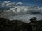 View from mountain range to the valley above fog and clouds