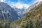 View at mountain ravine with snow capped mountain peaks