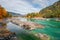 View of the mountain river Katun in the Altai mountains, emerald color of water and stones, autumn colorful forest and leaves