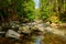 View of the mountain riverbed with large rocks and a rapid river