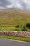 View on a mountain from a road, Connemara, Ireland.Peak is covered with clouds.