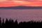 View from mountain Schoeckl over low stratus Koralpe with sunset