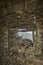 View of mountain through stone window frame in Corsica