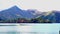 View of the mountain surrounded Lake Chuzenji with a speed boat running and the colorful foliage of autumn