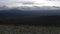 View from the mountain top on a beautiful forested valley. Clip. National park with green hills on cloudy sky background