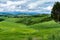 View of the mountainous meadow covered by dense clouds.