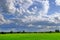 View of mountains, sky, streams among green forests.