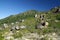 View of the mountainside with huge stones with blue clear sky on the background