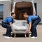 View of movers holding armchair in