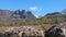 The view of mt ossa rom the overland track with dolerite boulders in the foreground