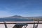 View of Mt Vesuvius from balcony with tables and chairs, Pompeii