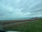 The view of the muddy road from a RV Sprinter Van stuck in the mud in the Wall, SD boondocking spot in Badlands National Park