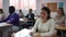 view of multiethnic group of adult people sitting in row and making notes during professional training