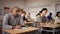 view of multiethnic group of adult people sitting in row and making notes during professional training