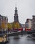 A view of Munttoren tower in Amsterdam from across the river Amstel on an autumn morning.