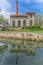 View of the Museum of electricity, building with chimney in industrial brick, mirrored on Paiva river