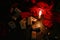 View of the mystical composition of wooden runes around the petals of red roses, a candle burns next to it and the burnt matches