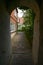 View through a narrow corridor into a small residential alley, typical in the medieval old town of Luebeck, Germany, selected