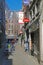 View on narrow typical belgian alleyway with shops and cafes