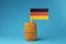 A view on national flag of Germany on wooden stick in wooden barrel