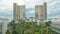 View of the National Library of France timelapse, whose four buildings in the form of open books surround a wooded area.