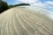 View of the natural dunes at the beach with wave sand pattern Beautiful background.