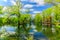 View of natural landscape at Toronto Center island near the pond area with people walking and relaxing in background