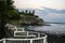 View of natural rocky beach and cliff with palm trees in El Tunco, El Salvador. Stones and rocks on the beach at sunset or sunrise