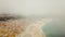 View on Nazare atlantic coast and sandy beach in Portugal. Flight on a drone in the clouds