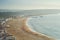 View Nazare beach riviera with cityscape of Nazare town at sunny weather. Portugal.